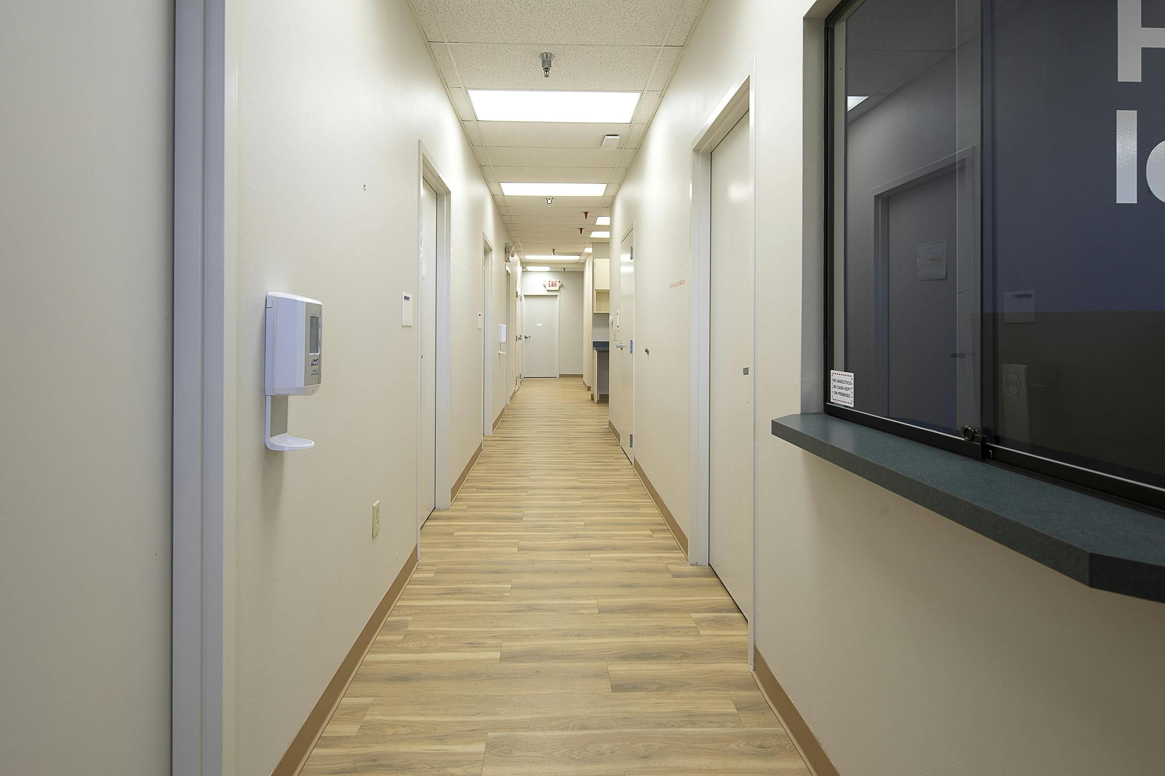 Hallway with doors and wood floors at Cityblock Greensboro