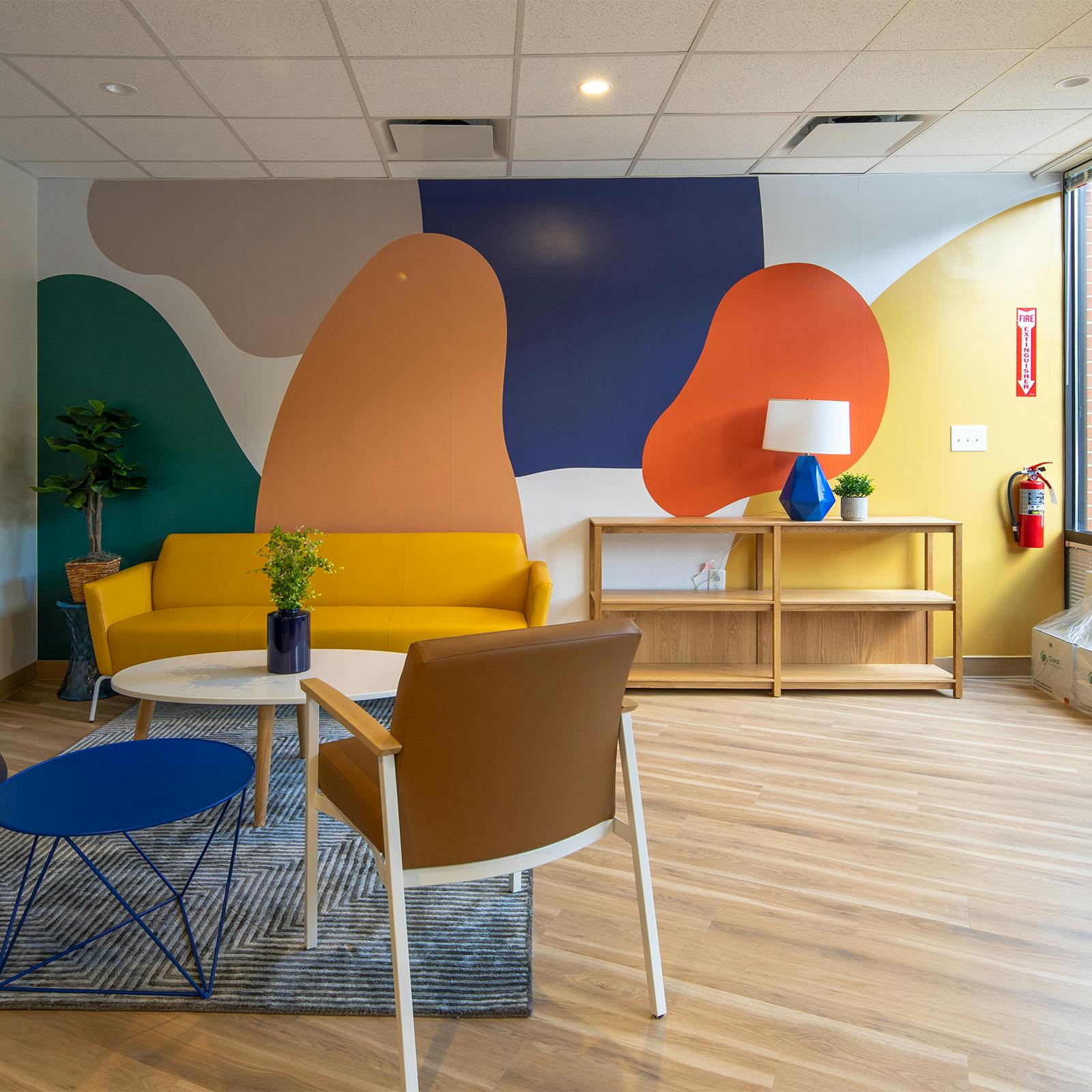 Cityblock hub reception room with chairs and multicolor wall mural art.