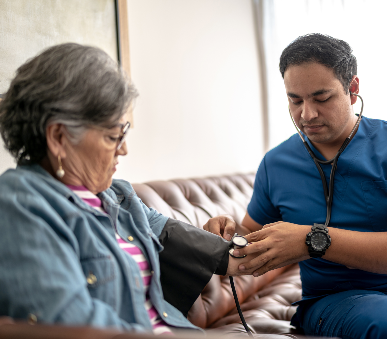 Woman gets blood pressure checked at home by male provider