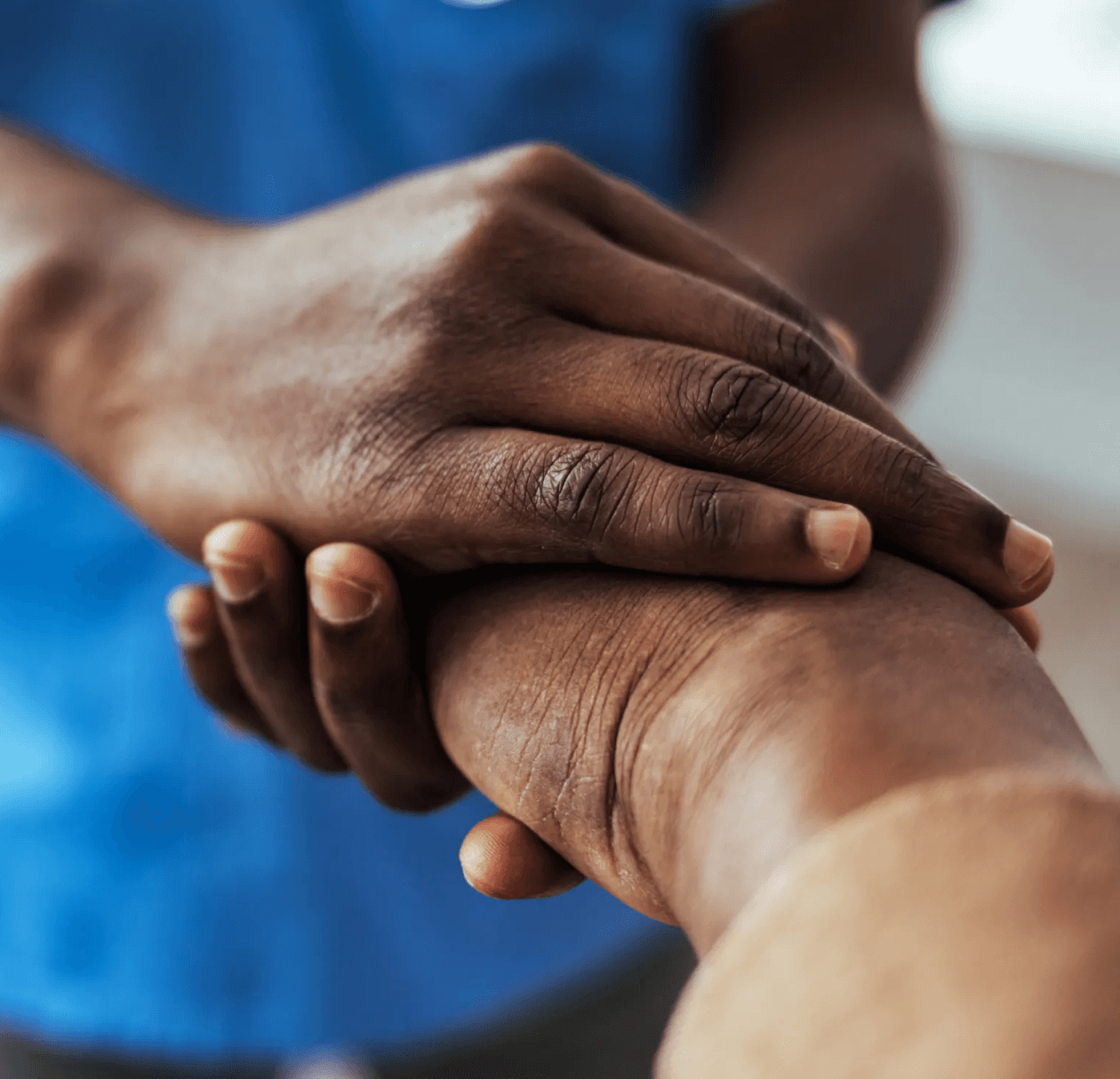 Person holds the hand of someone reaching out.