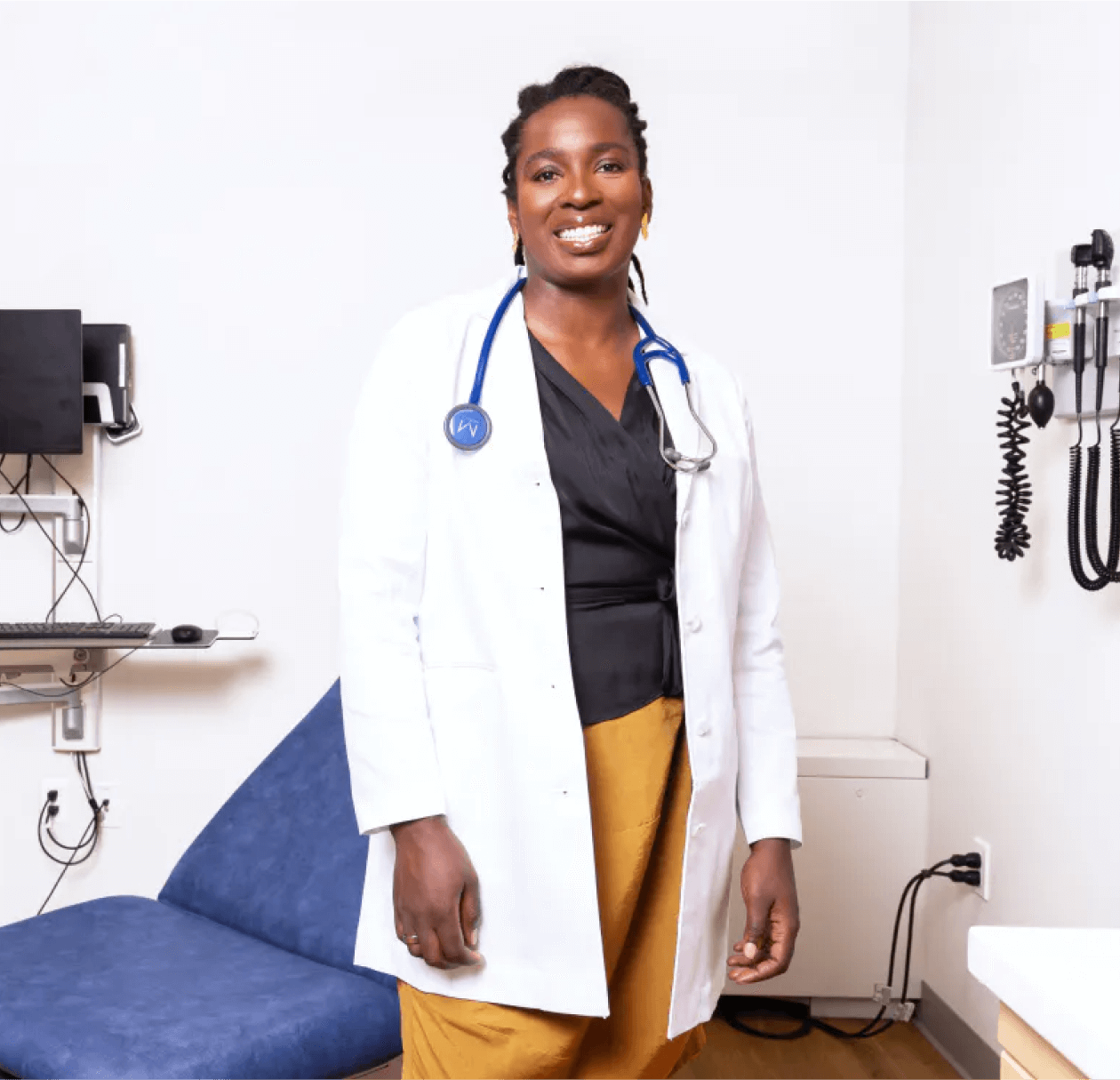 Image of Cityblock's CEO Dr. Toyin Ajayi wearing a white coat smiling proudly.