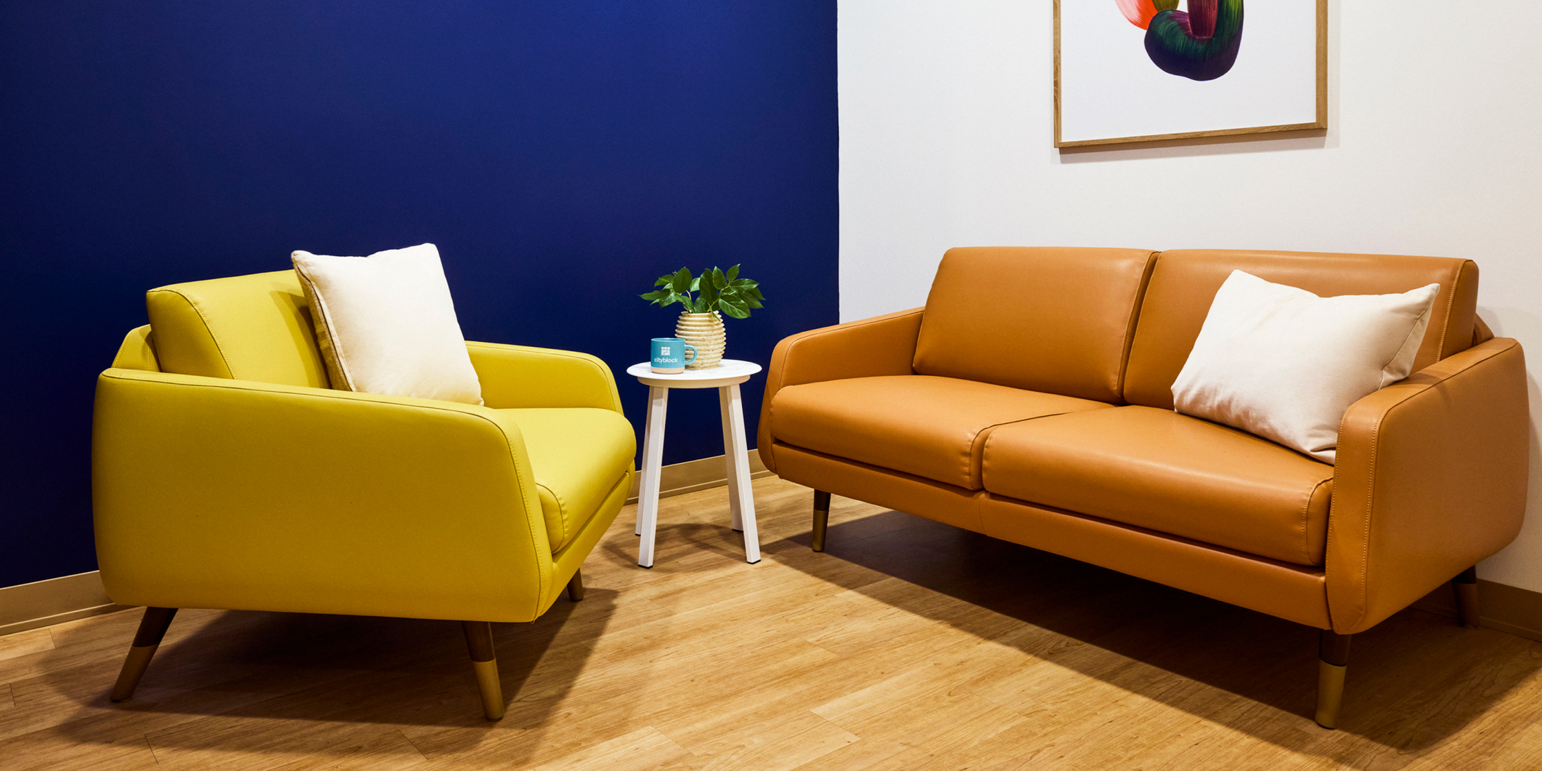 Sitting room with a yellow chair and a tan couch.