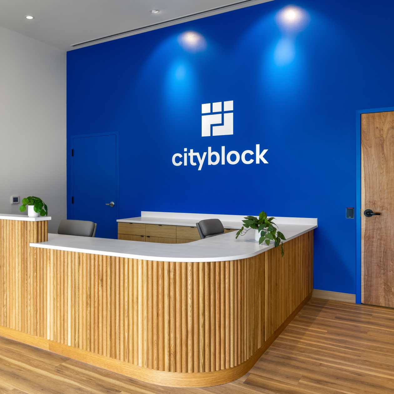 Cincinnati clinic front desk and blue wall with Cityblock logo.
