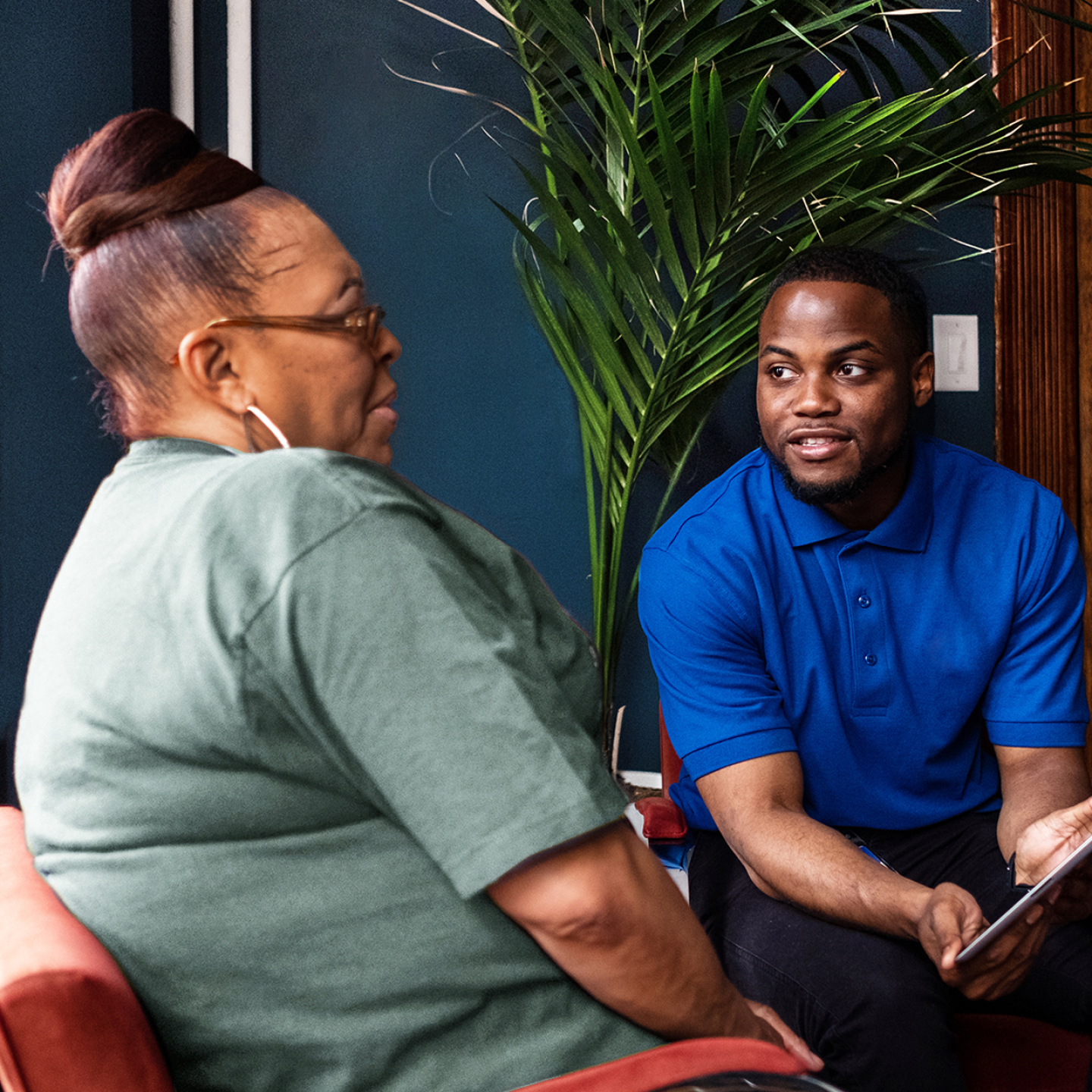 Photo of a Cityblock employee showing a member information on a tablet