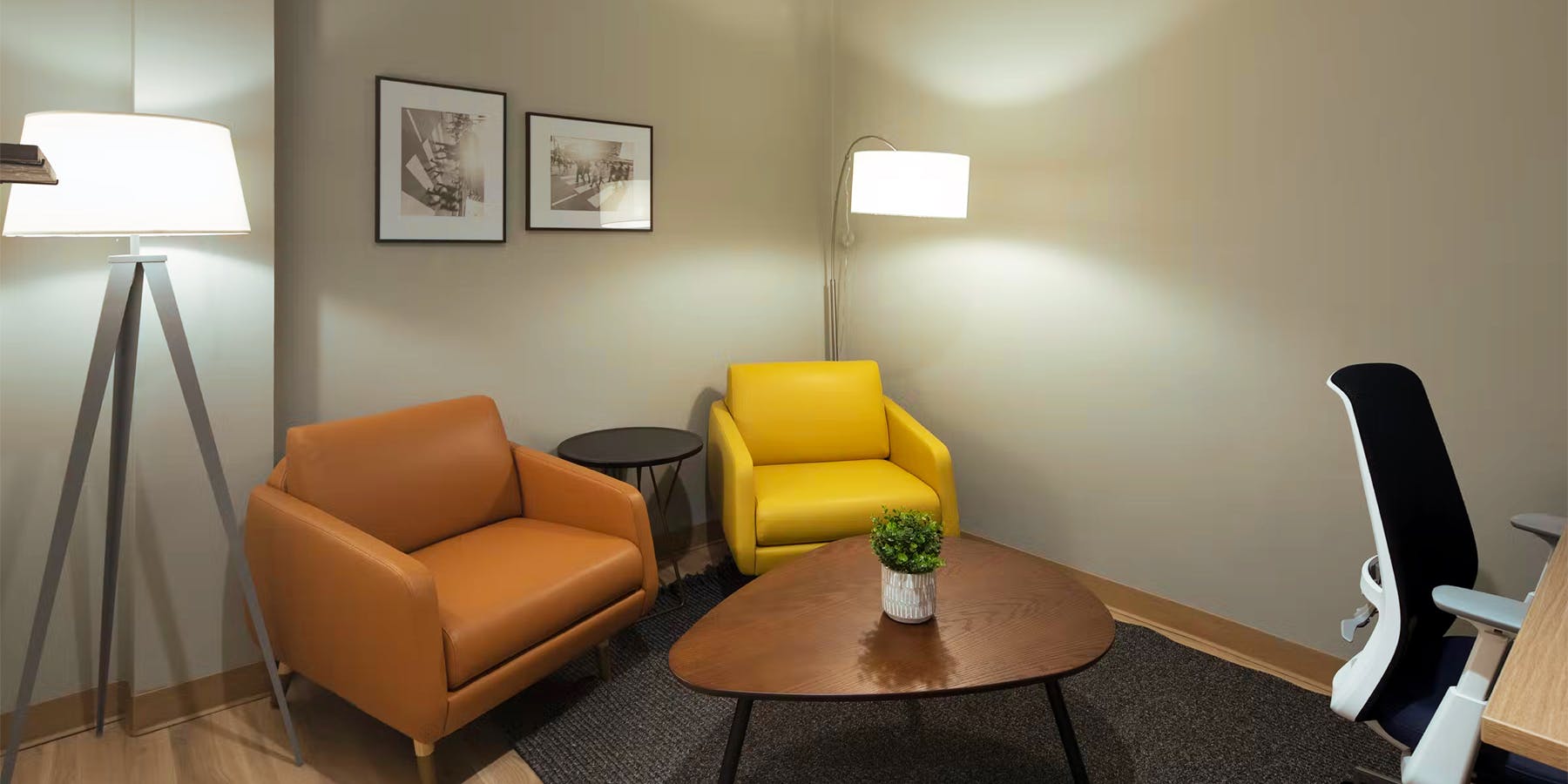Sitting room with tan and yellow chairs at Cityblock Winston-Salem, North Carolina.