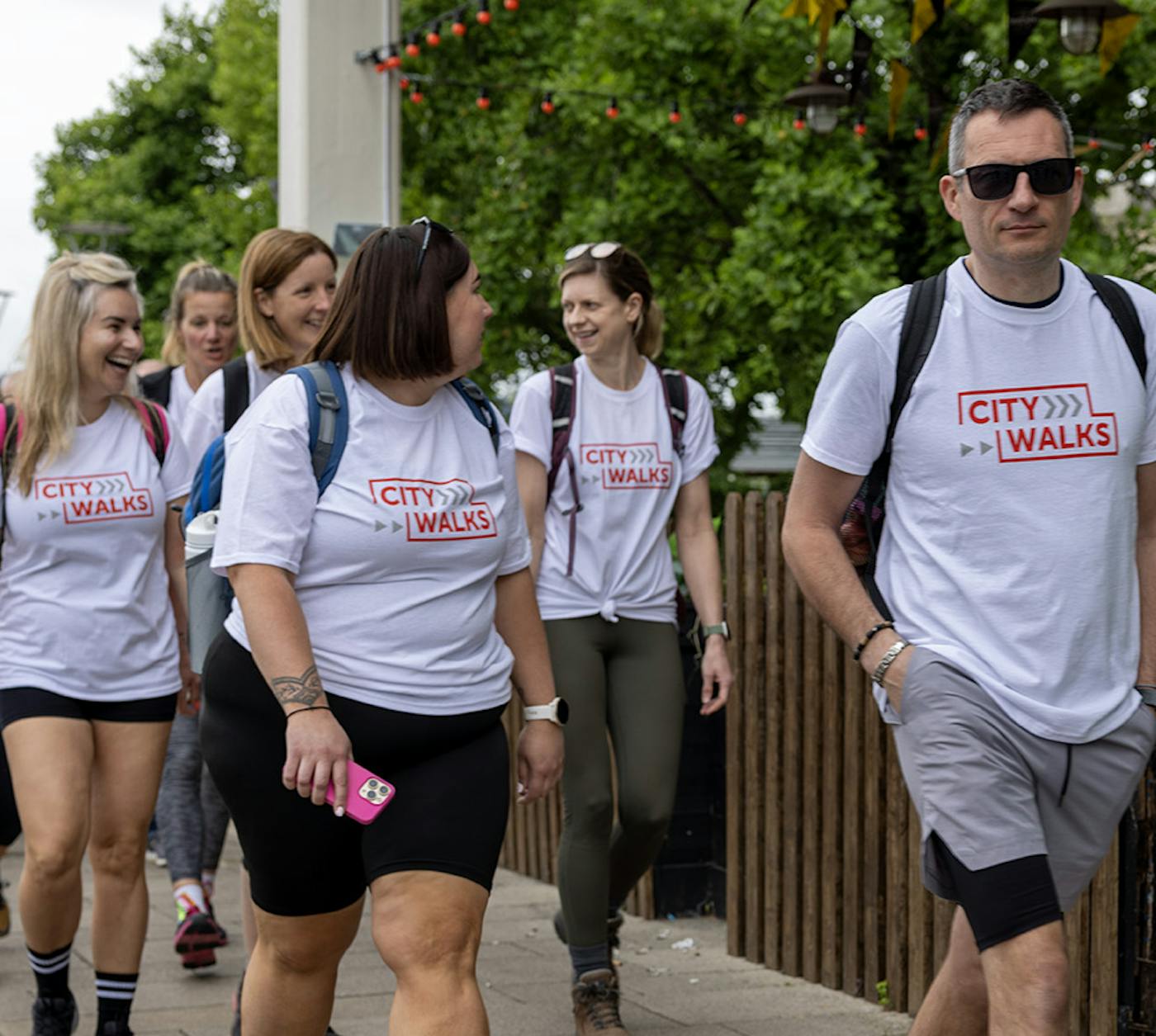 Photo of City Walkers in their Crisis t-shirts, smiling and laughing with one another.