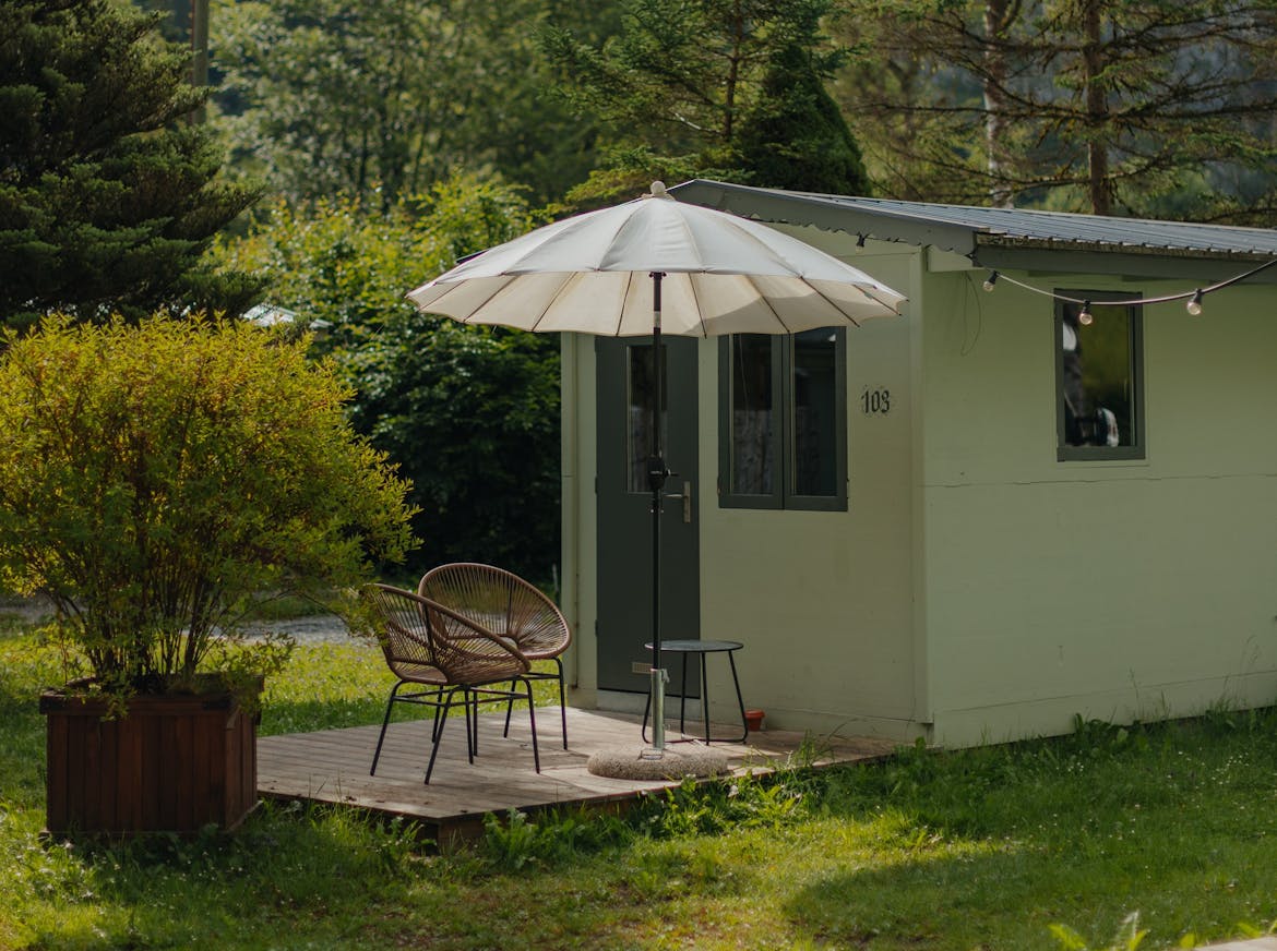 rental accommodation fox cabin for two people with a terrace, two chairs and a parasol