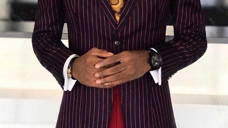 A young man in suit, tie and matching trouser