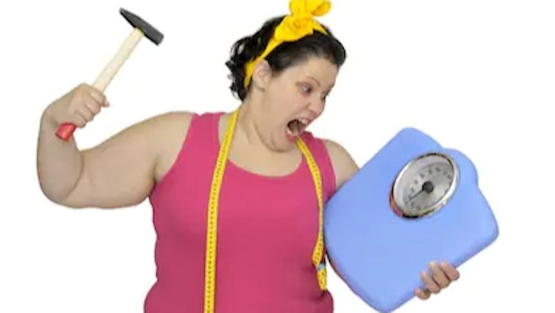 An angry woman unsatisfied with her weight