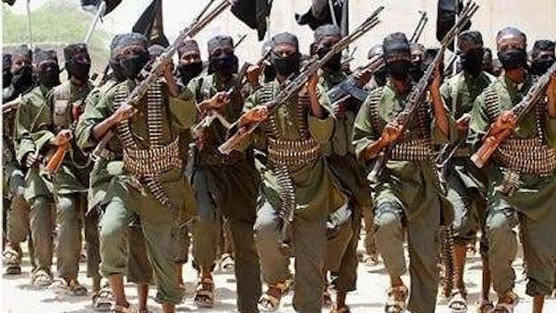 Armed men with guns and bullets on their waist with face masks