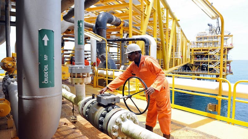 A worker in an oil company losing a nut
