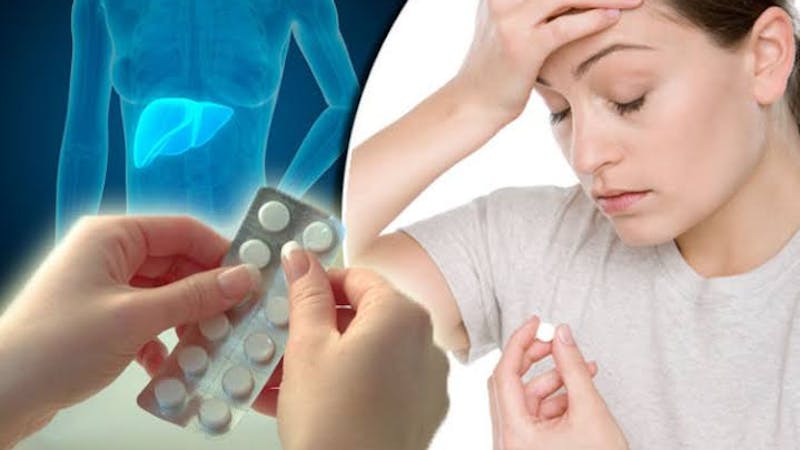 A woman experiencing symptoms of headache taking acetaminophen (paracetamol)