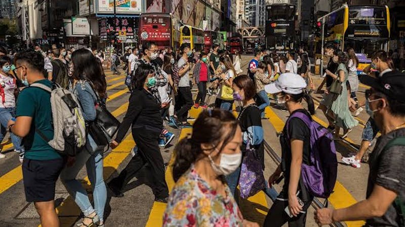 People wearing face masks going about their normal activities in the Causeway bay shopping district Hong Kong