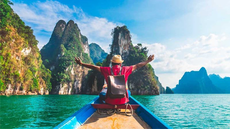 A man in boat cruise on a vacation - Top 10 ways to travel the world
