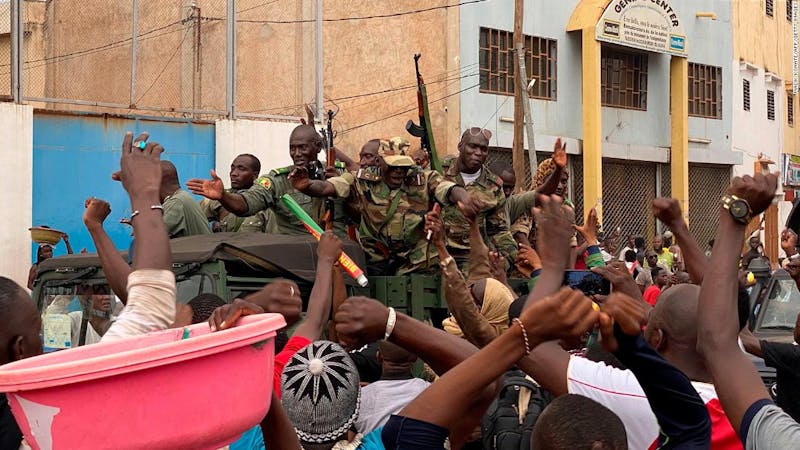 Malian soldiers celebrated as they arrive indepence square in Bamako following the resignation of the president, Keita