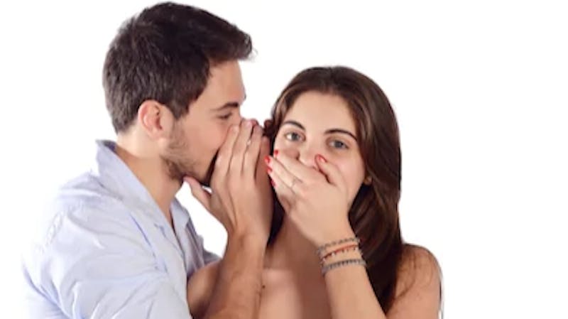 A man telling his girlfriend a secret: Communication in marriage and relationship. Should partners tell each other everything including secrets?