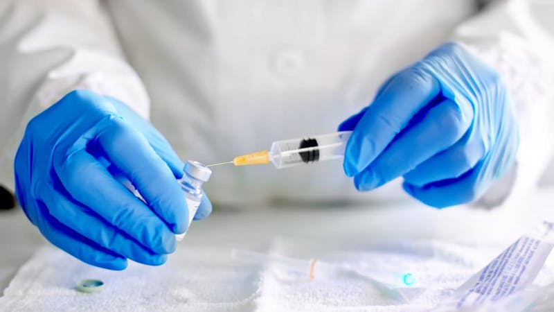 A health personnel testing COVID-19 vaccine