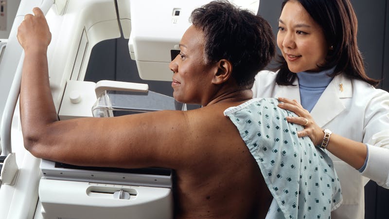 A woman screened to check for a malignant tumour (cancer)
