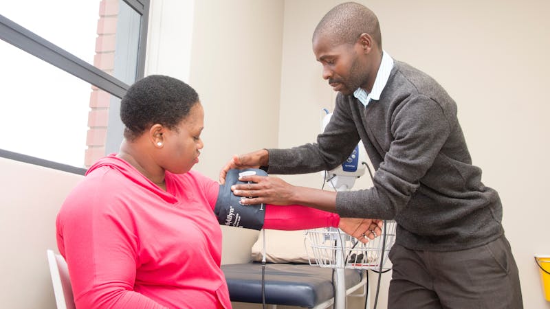 A doctor taking a patient's blood pressure