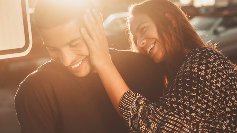 A young man with his girlfriend playing in a romantic way