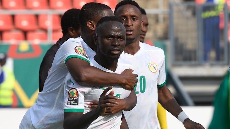 Senegal players hug Sadio Mane after his winner at AFCON 2021