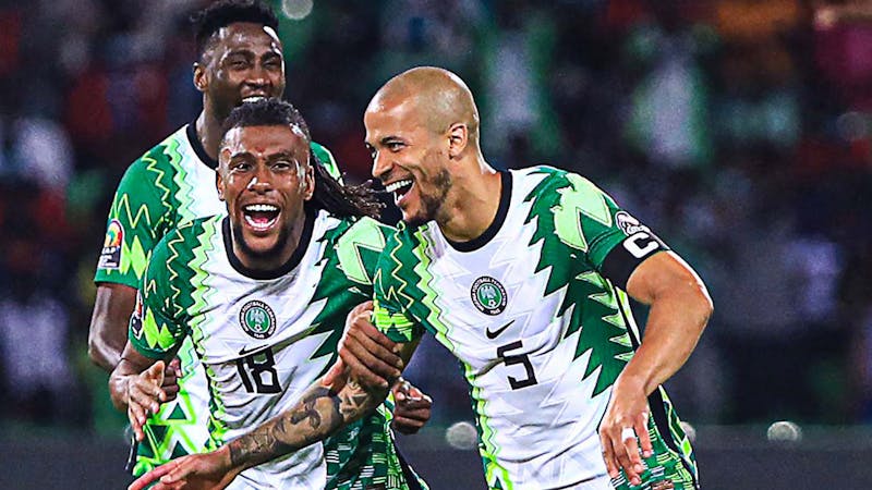 William Troost-Ekong laughs with Alex Iwobi after scoring for Nigeria against Guinea-Bissau at AFCON 2021