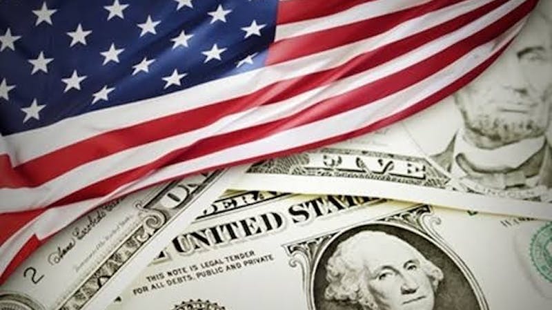 American flag and the US dollar: United States economy plunged into economic recession as a result of the COVID-19 pandemic