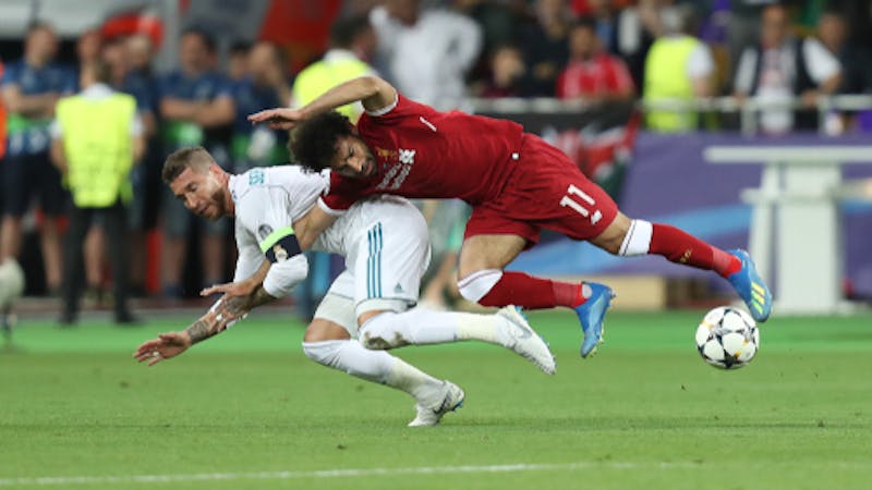 KYIV, UKRAINE - MAY 26, 2018: Mohamed Salah gets injury after tough tackle by Sergio Ramos. UEFA Champions League final Real Madrid - Liverpool. Olympic NSC stadium.