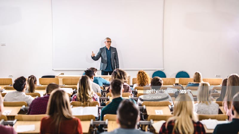 Schools, a teacher in a classroom with students