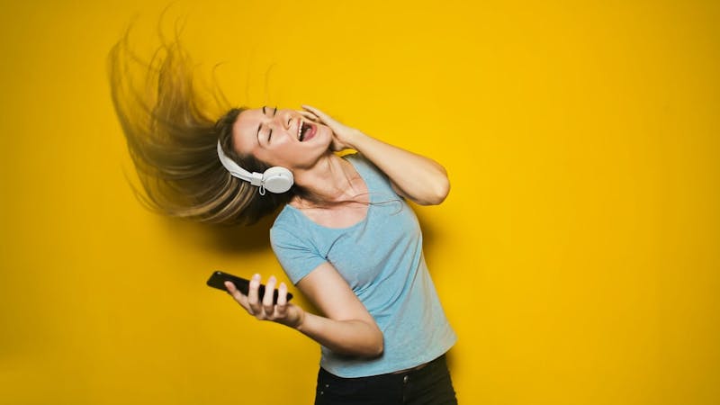 A woman with a headphone listening to music