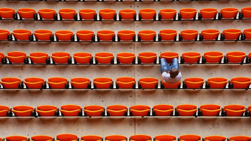 A fan watching a match while in the stadium.