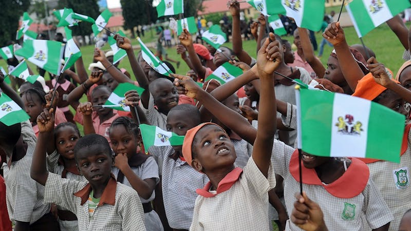 School children holding Nigeria flag