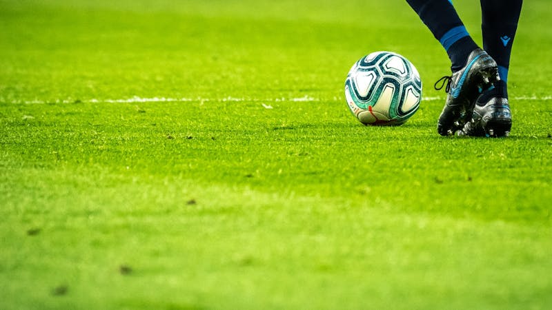 A football player moving with the ball.