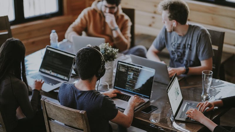 A group of company IT technicians and developers working on a project
