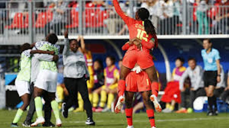Female footballers rejoice in the pitch