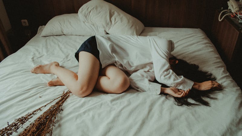 A sick girl suffering from food poisoning