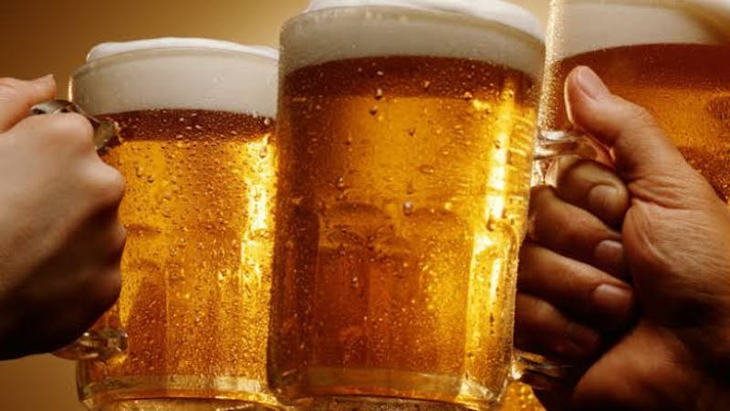 Men drinking beer from glass cups