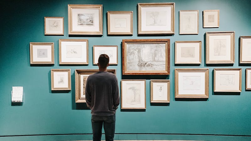 An individual watching art collections.
