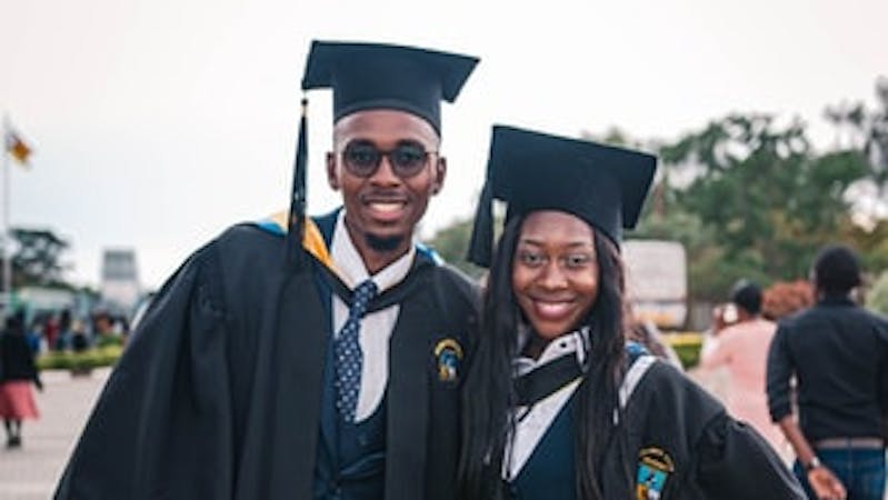 Image of two Black students on graduation day.