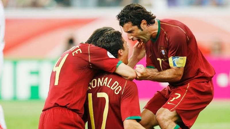 Portugal's Luis Figo and Nuno Valente (L) celebrate Cristiano Ronaldo's (C) goal against Iran during their Group D World Cup 2006 soccer match in Frankfurt June 17, 2006.