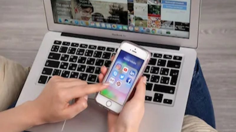 A woman creating a Gmail account using her PC and mobile phone