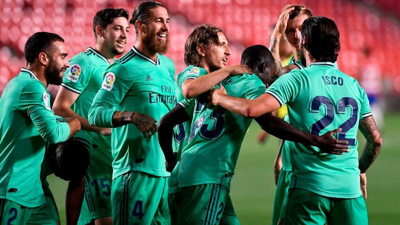 Real Madrid players celebrating Mendy's goal against Granada