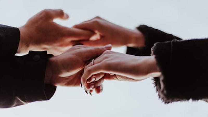 Friends extending hands of friendship