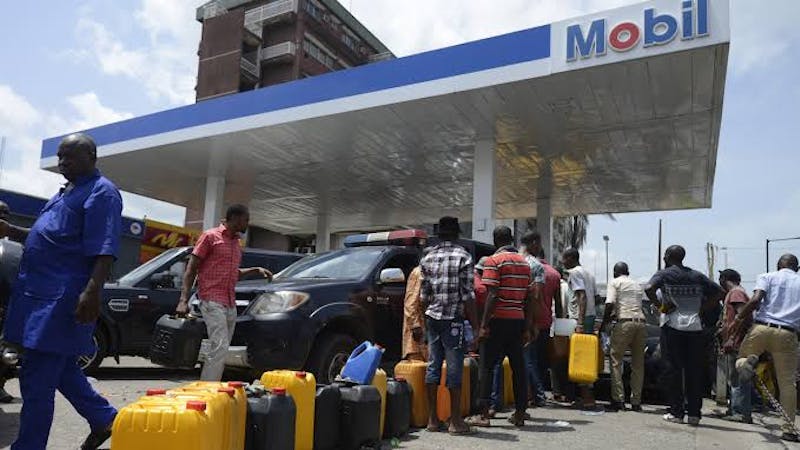 Nigerians queued to buy petrol from a petrol station