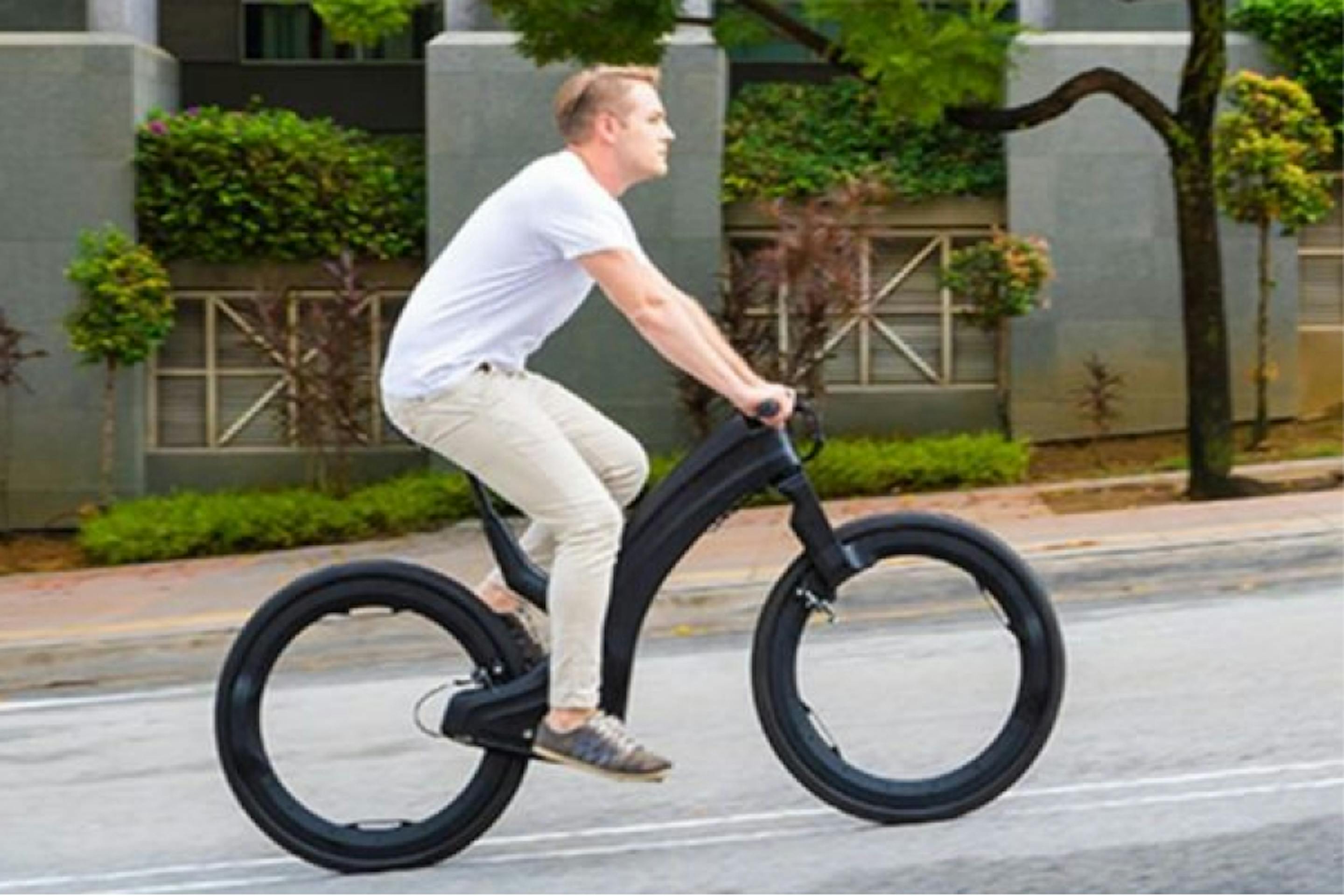 Man on futuristic looking bicycle