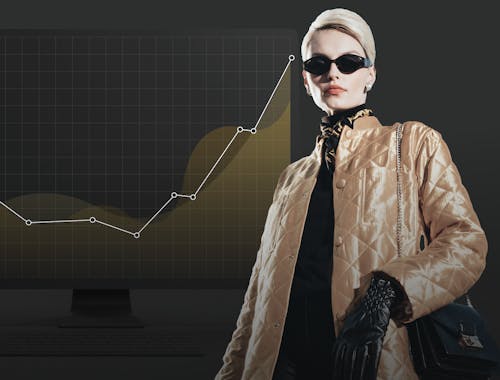 A woman stands in front of a chart showing upward growth.