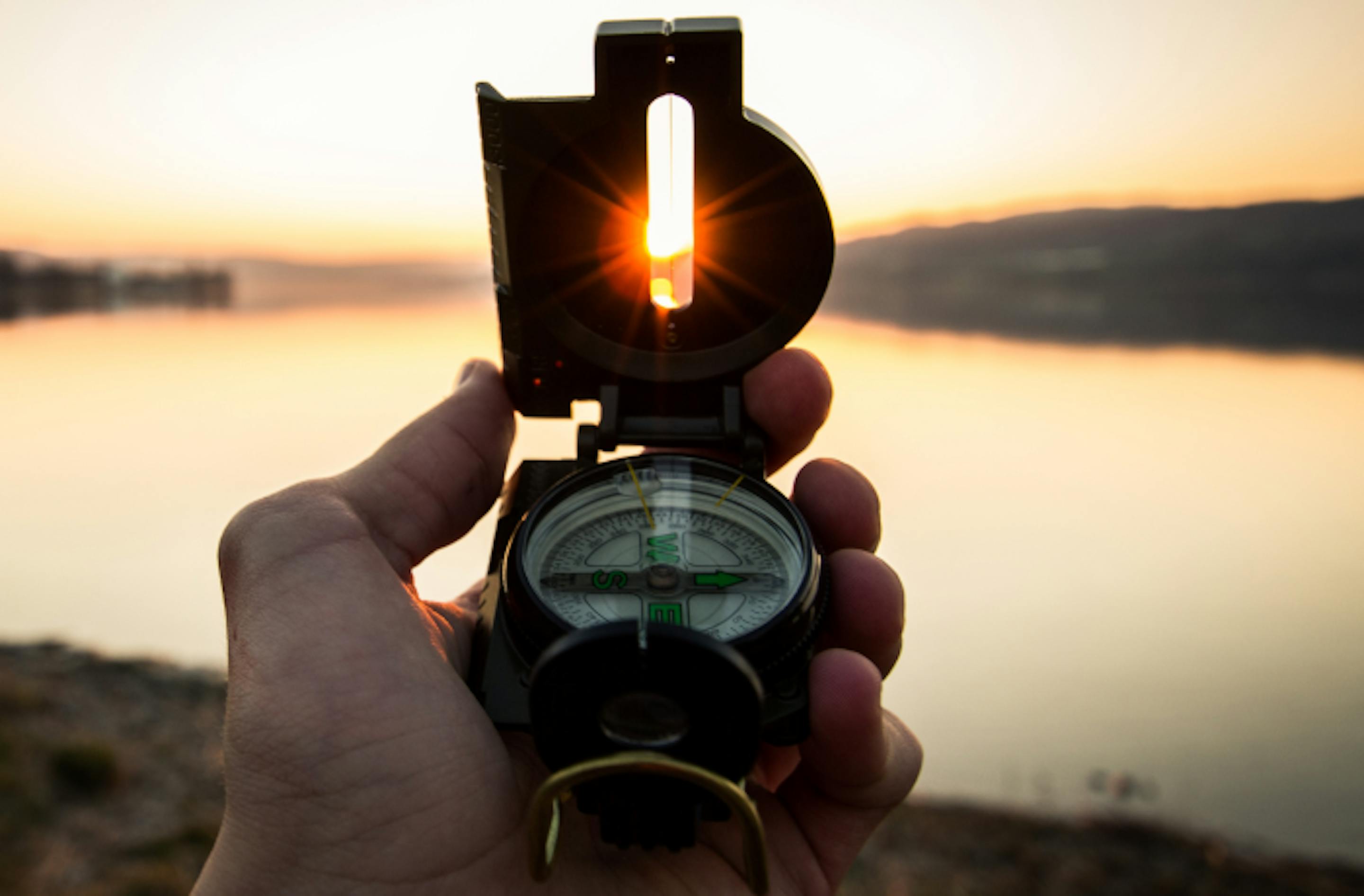 compass pointing at the sun