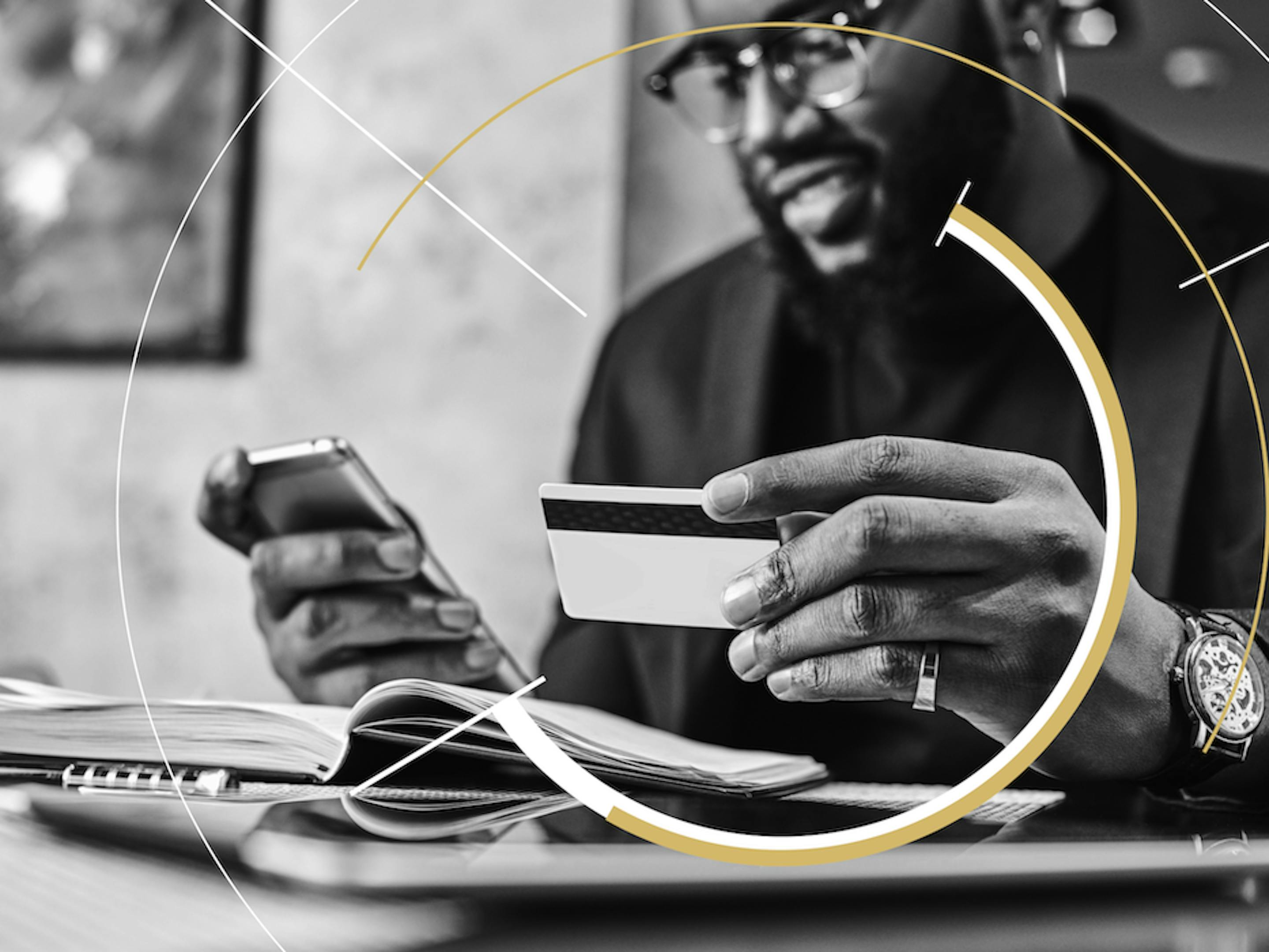 A man checks his credit card number while making a purchase on his phone.
