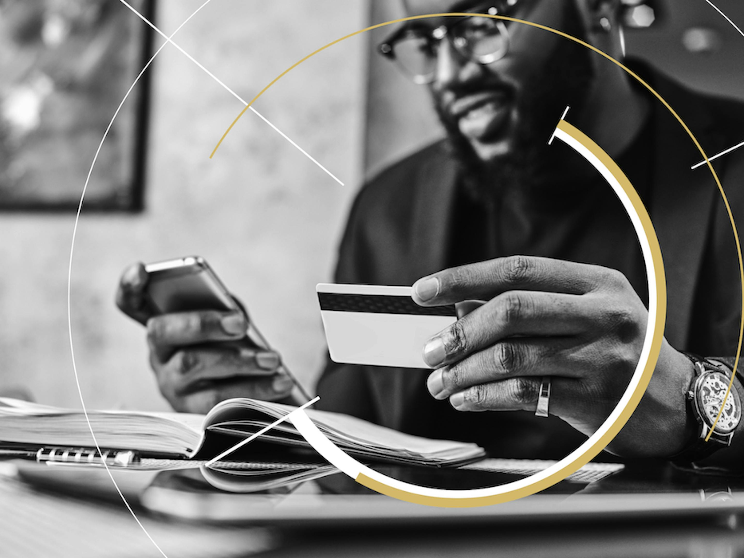  A man checks his credit card number while making a purchase on his phone.