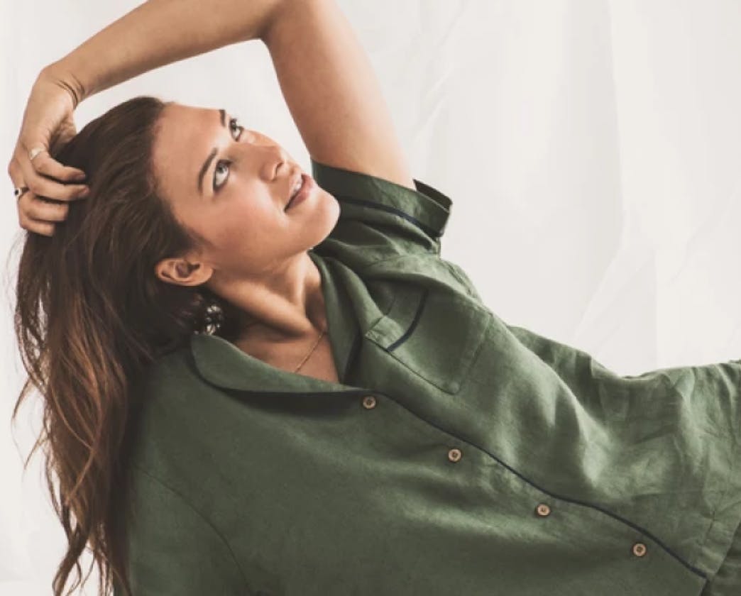 Model in green shirt looking upwards